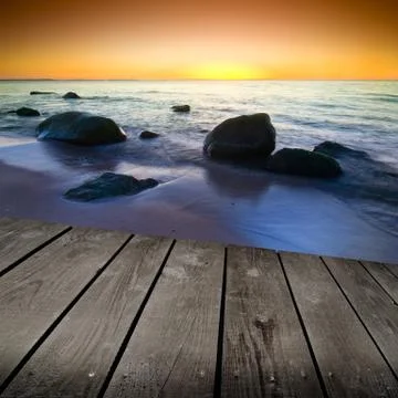 Sunset and empty wooden deck table. Stock Photos