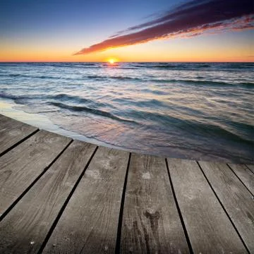Sunset and empty wooden deck table. Stock Photos