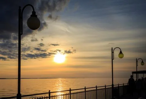 Sunset and lanterns on the pier Фото