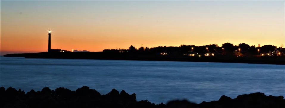 Sunset and lighthouse Stock Photos