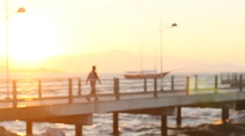 Sunset and men walking alone trough the pier Video stock 26243729
