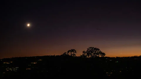 Sunset and Moonset as Night falls and City Lights Twinkle On Stock Footage 284297675