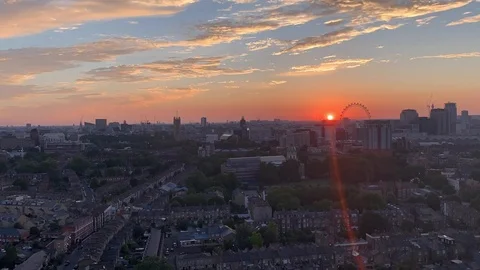 Sunset and moonset over London Eye and Big Ben Stock Footage