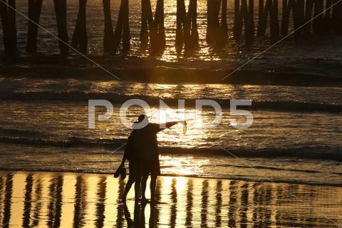 Sunset and pier Stock Photos