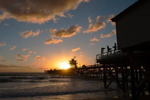 Sunset and pier Stock Photos