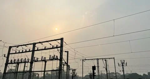 Sunset and power grid in front Stock-Fotos