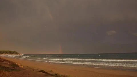 Sunset and rainbow in Platja Llarga beach, Tarragona, Spain Stock Footage 153962161