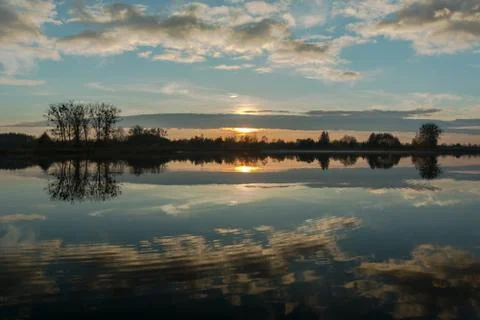 Sunset and reflection of clouds in lake Stock Photos