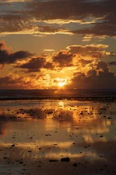 Sunset and reflection of sunset over beach / Indian Ocean, Seychelles Stock Photos