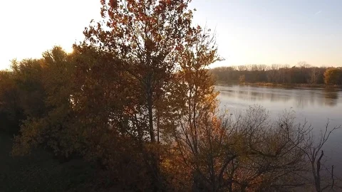 Sunset and the River with Beautiful Fall Colored Trees Stock Footage
