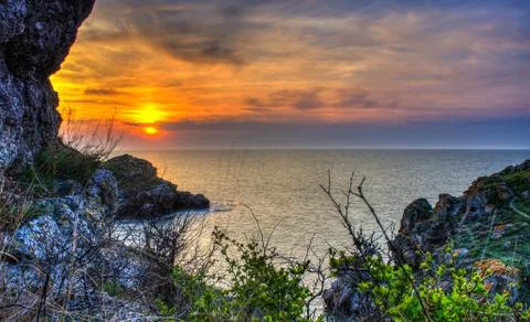 Sunset and rocks Stock Photos