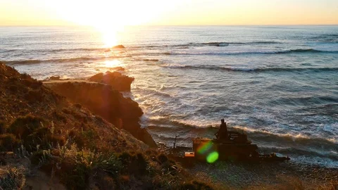Sunset and the silhouette of a decaying ship wreck, Portugal Stock Footage 87330637
