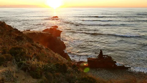 Sunset and the silhouette of a decaying ship wreck, Vila Nova de Milfontes Stock Footage 87330677