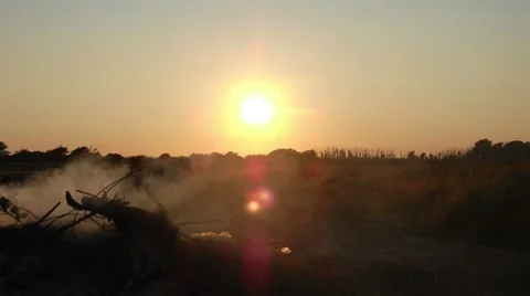 Sunset and smouldering fire Time lapse Stock Footage 8359800