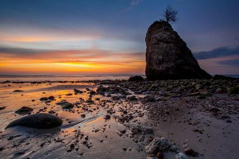 Sunset and standing stone Stock Photos