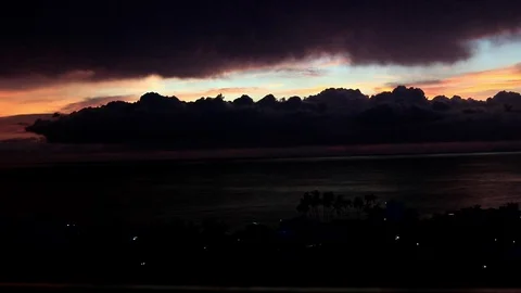 Sunset and storm over beach town Stock Footage 81158046