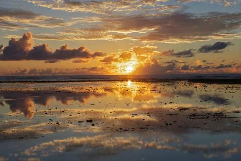Sunset and sunset reflection over shallows / beach, Seychelles. Indian Ocean Stock Photos