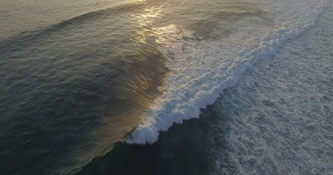 Sunset and surfers relaxing while waves are crashing at Beach in Costa Rica. Stock Footage