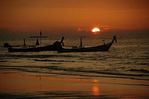 Sunset and tailboats Stock Photos