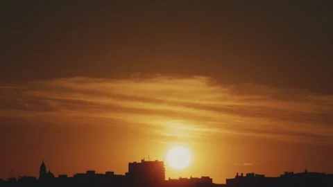 Sunset and a view of the rooftops of the city. Timelapse Stock Footage 316968444