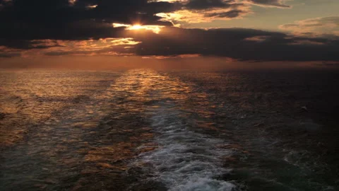 Sunset and wake of a ship Видео 106464102