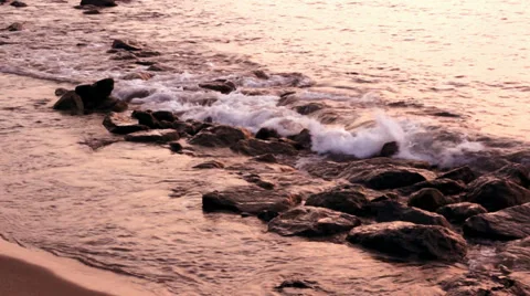 Sunset and the wave of the sea on a background of stones in Lombok, Indonesia Stock Footage 37732010