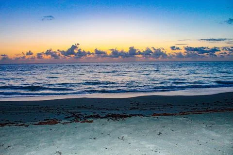 Sunset and waves on the shore Stock Photos