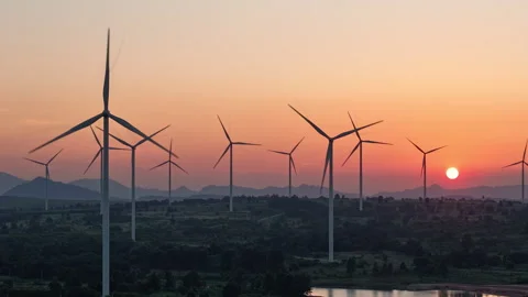 Sunset and wind turbines in a wind farm in the countryside Stock Footage 312812052