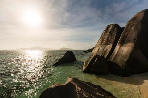 Sunset at Anse Source D'Argent in La Digue, Seychelles with granite rocks in  Stock Photos