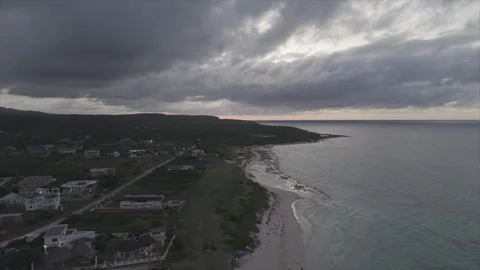 Sunset ascending over beautiful beach Stockbeeldmateriaal 335434347