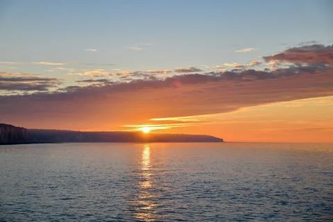 Sunset on the Atlantic ocean in Normandy and reflection on a water. Stock Photos