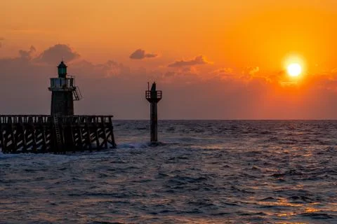 Sunset on the Atlantic ocean, view on lighthouse. Wallpapers concept. Stock Photos