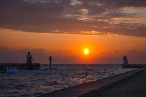 Sunset on the Atlantic ocean, view on lighthouse. Wallpapers concept. Stock Photos