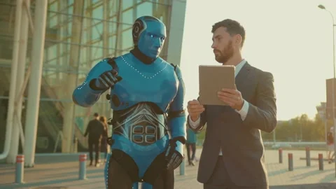 At sunset attractive man use tablet computer talking with humanoid robot shake Stock Footage 133299656