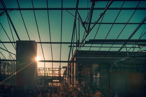 Sunset with back light in an old rusted industrial area Stock Photos