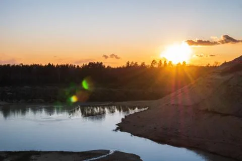 Sunset in the background of an abandoned quarry. Stock Photos
