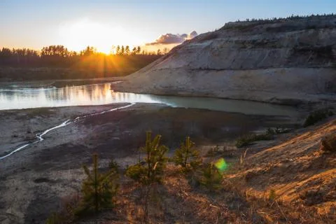 Sunset in the background of an abandoned quarry. Stock Photos
