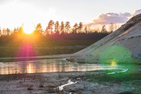 Sunset in the background of an abandoned quarry. Stock Photos