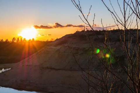 Sunset in the background of an abandoned quarry. Stock Photos