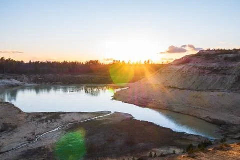 Sunset in the background of an abandoned quarry. Stock Photos