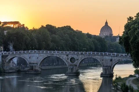 Sunset on the background of the bridge over the Tiber in Rome overlooking the do Stock Photos