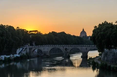 Sunset on the background of the bridge over the Tiber in Rome overlooking the do Stock Photos