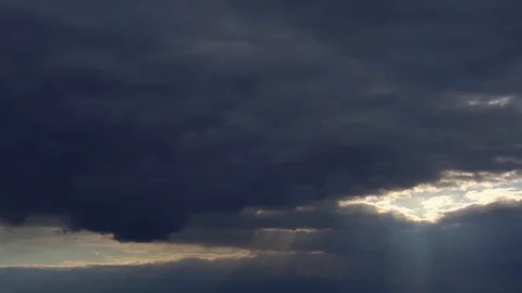 Sunset on a background of dark clouds Stock Footage 129927198