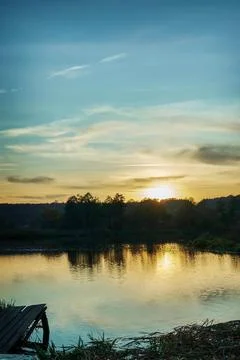 Sunset on the background of the lake. Stock Photos