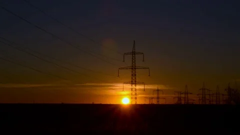 Sunset on the background of power lines | Stock Video | Pond5