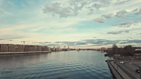 Sunset on the background of the river and buildings under construction Video stock 305455624