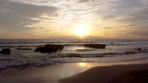 Sunset in bali the waves are breaking on the beach the sky is very beautiful 库存影片 126970823