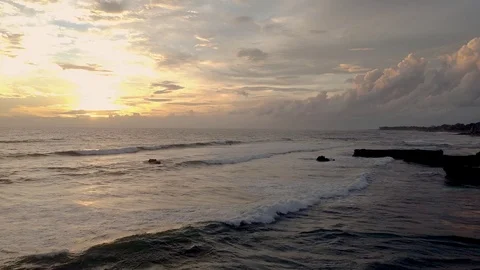 Sunset in bali the waves are breaking on the beach the sky is very beautiful Vídeo Stock 126976021