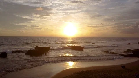 Sunset in bali the waves are breaking on the beach the sky is very beautiful 库存影片 126976267