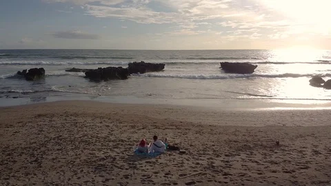 Sunset in bali the waves are breaking on the beach the sky is very beautiful 库存影片 126976576